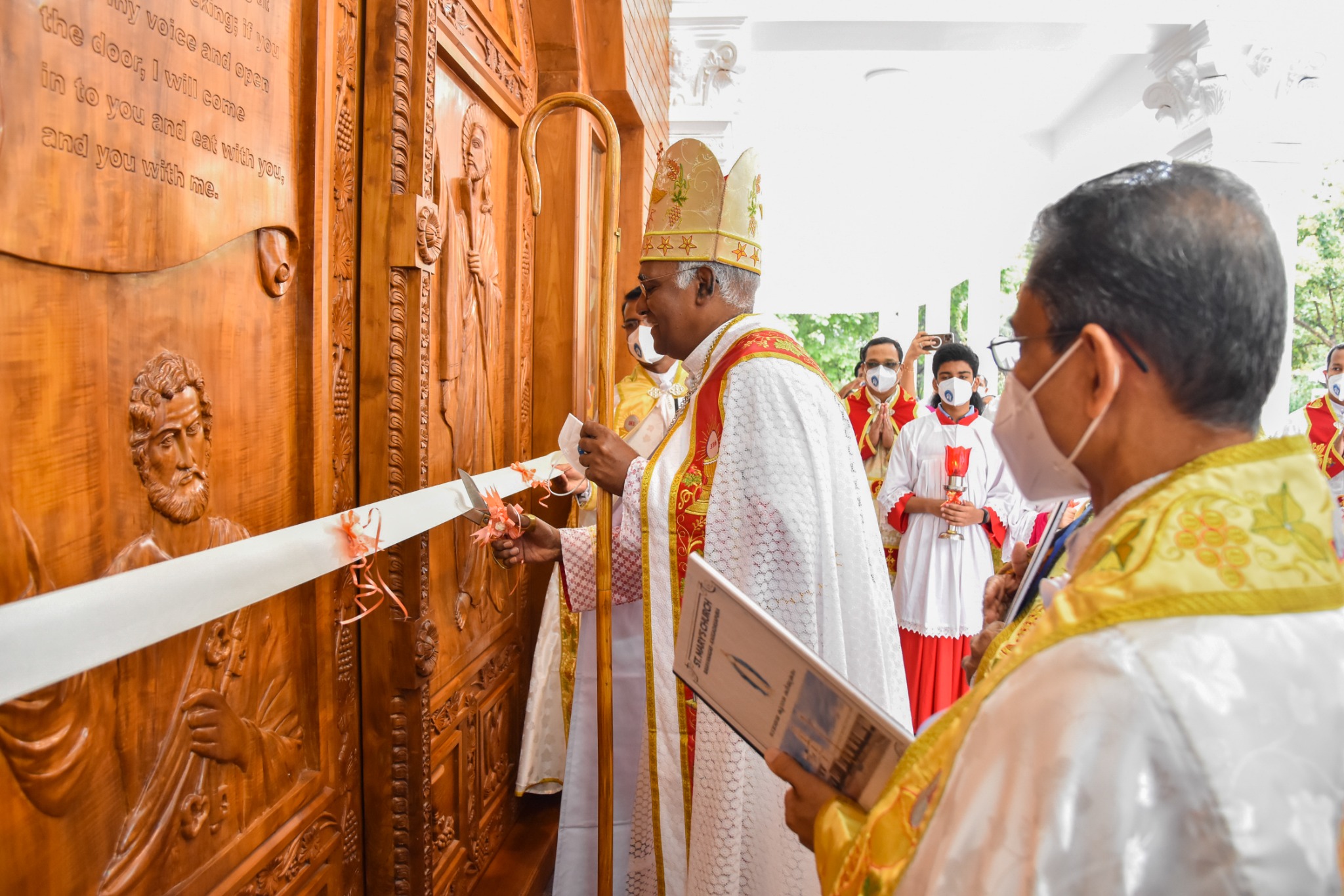Bishop opening the carved church doors