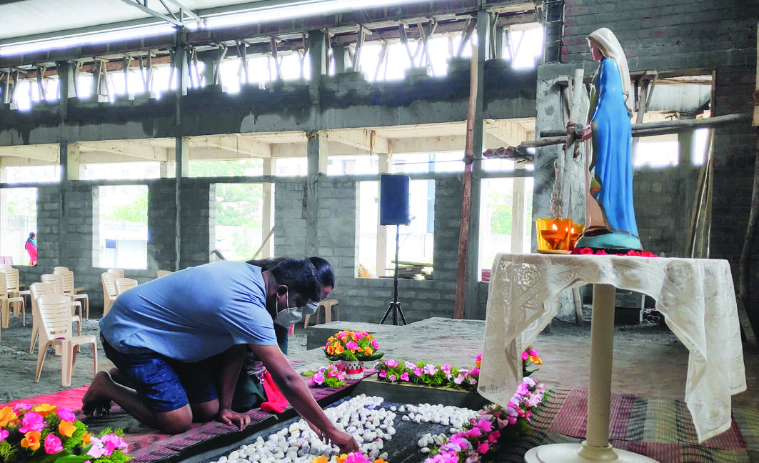 A parishioner praying during the church construction