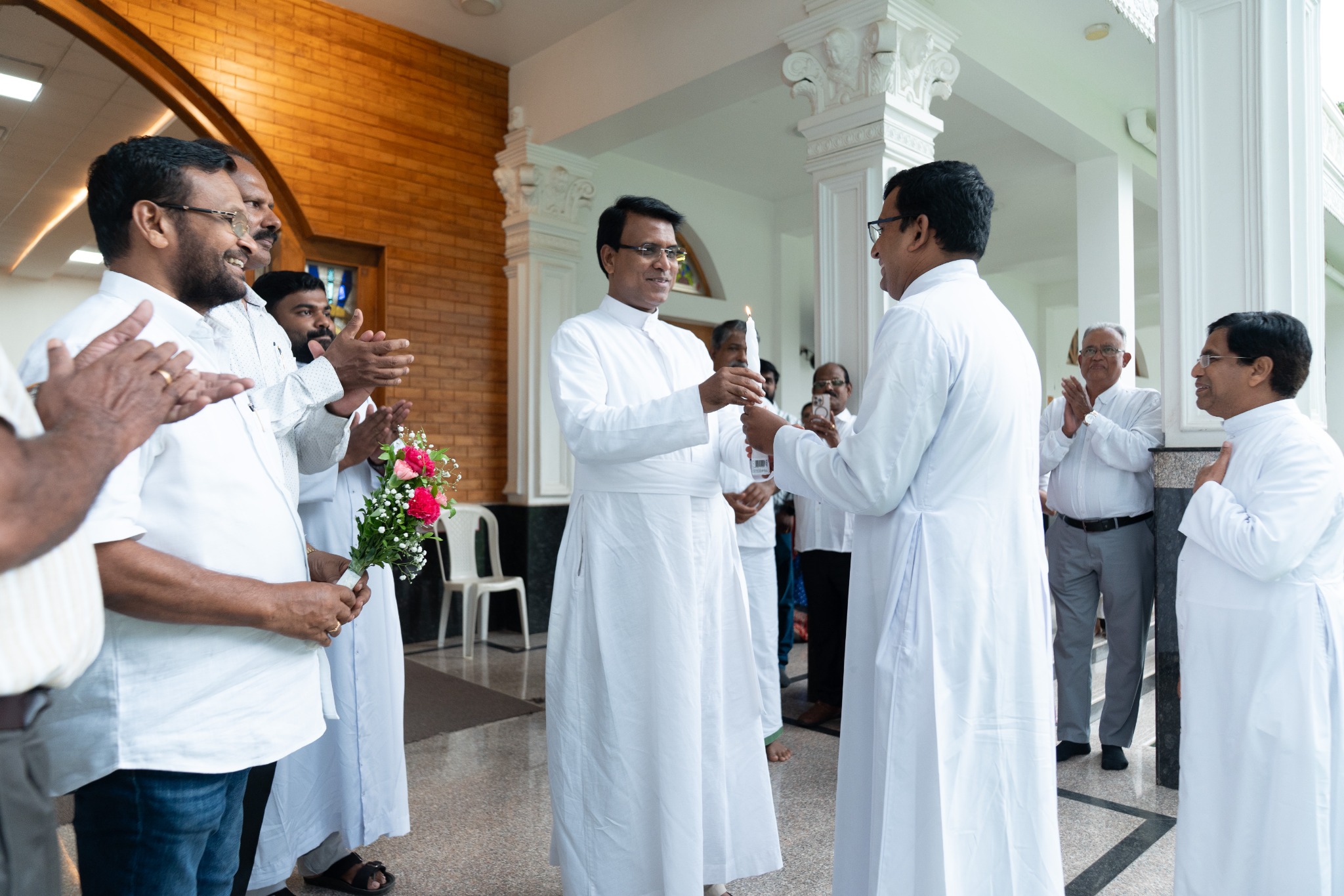 Clergy receiving a candle at the church entrance