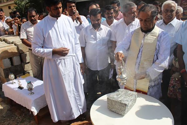 Priest blessing the foundation stone at the early parish building site
